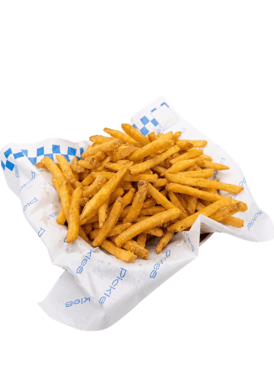 Porção generosa de batatas fritas douradas servida em papel estampado